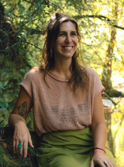 Bénédicte Donet, psychologue en ligne, assise au bord d'une rivière en pleine nature